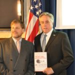 Eric Schwartzman with Ambassador David Thorne holding Eric's best selling book Social Marketing to the Busienss Customer, the first book on the use of social media for B2B digital marketing